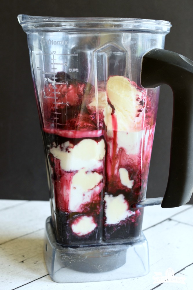 A blender with vanilla ice cream and purple grape juice