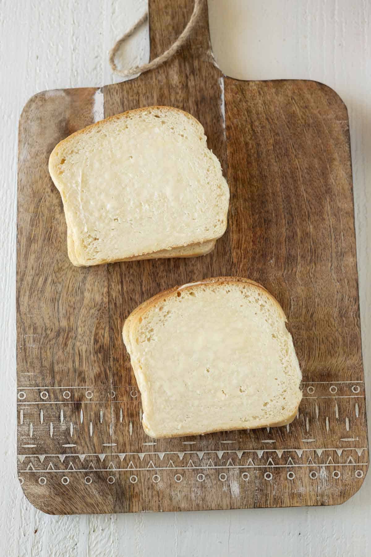 Buttered slices of white bread.