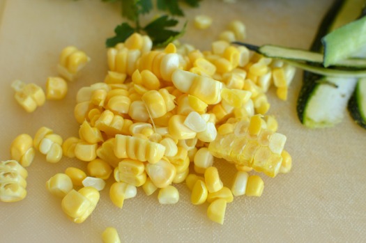 corn cut off the cob sitting on a cutting board