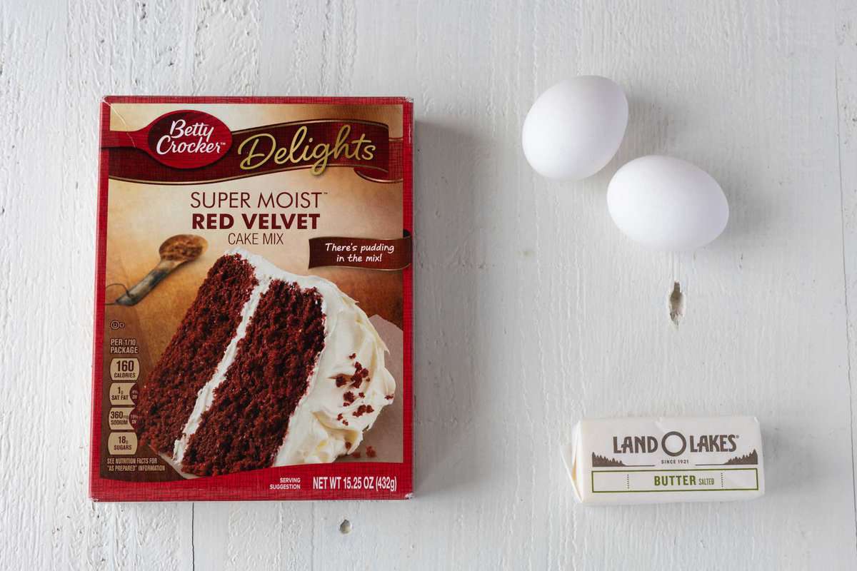 A red velvet box cake mix, two eggs, and butter. 