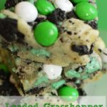 Cookie Bars with sugar cookie crust, topped with crushed oreos and green and white m&Ms