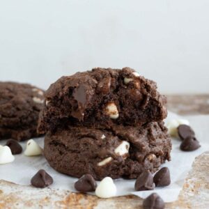 Half of a chocolate pudding cookie stacked on another cookie.