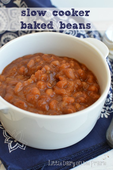 a white dish with baked beans in a tomato sauce