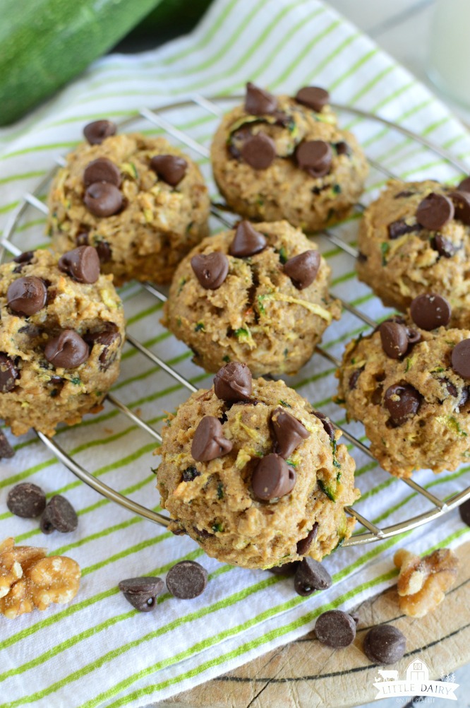 top view of zucchini breakfast cookies on a cooling rack with a green towel