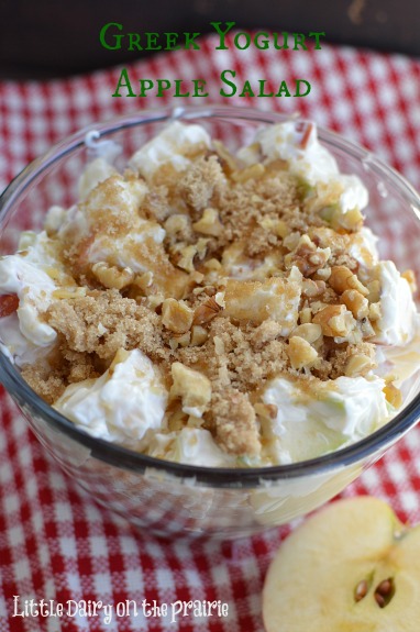 a glass bowl with creamy apple salad topped with brown sugar streusel