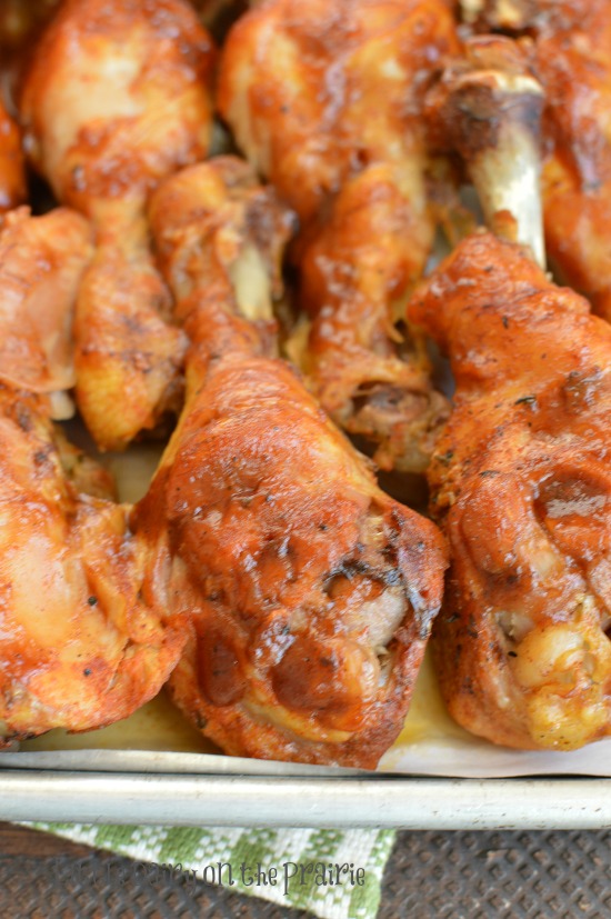 chicken drumsticks with BBQ sauce on a baking sheet