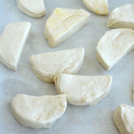 moon shaped biscuits on a baking sheet