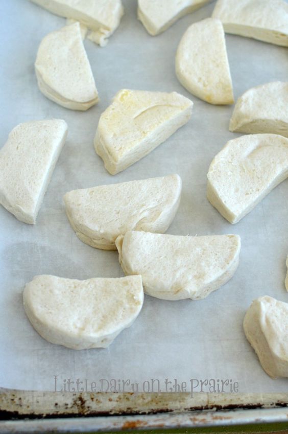 moon shaped biscuits on a baking sheet