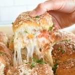 Make Ahead Pepperoni Pizza Sliders are an easy way to make pizza without having to fuss with making crust. They are perfect for packing in lunches. pitchforkfoodie.com #pizza #pepperoni #pepperonipizza #makeaheadmeals #freezereals #lunches #quickmeals #onthegomeals #sandwiches #pizzasandwiches #cheese #schoollunches