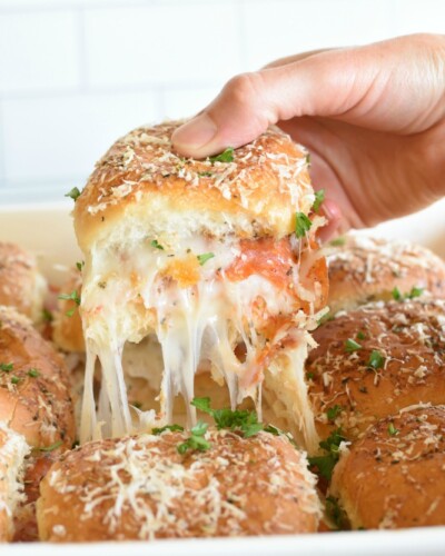 Make Ahead Pepperoni Pizza Sliders are an easy way to make pizza without having to fuss with making crust. They are perfect for packing in lunches. pitchforkfoodie.com #pizza #pepperoni #pepperonipizza #makeaheadmeals #freezereals #lunches #quickmeals #onthegomeals #sandwiches #pizzasandwiches #cheese #schoollunches