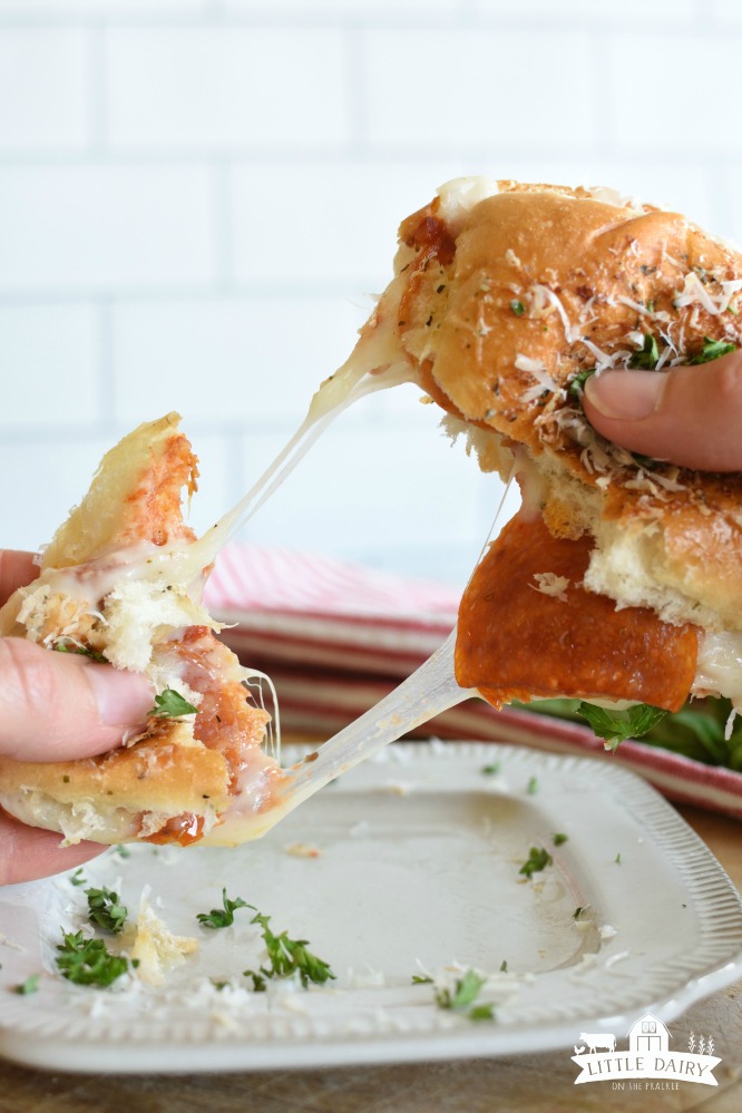 Pepperoni Pizza Slider being pulled apart by two hands