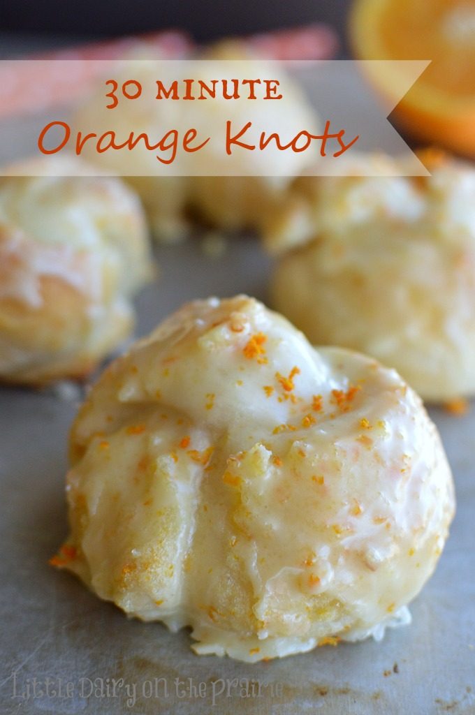 Baked orange knots on a baking sheet