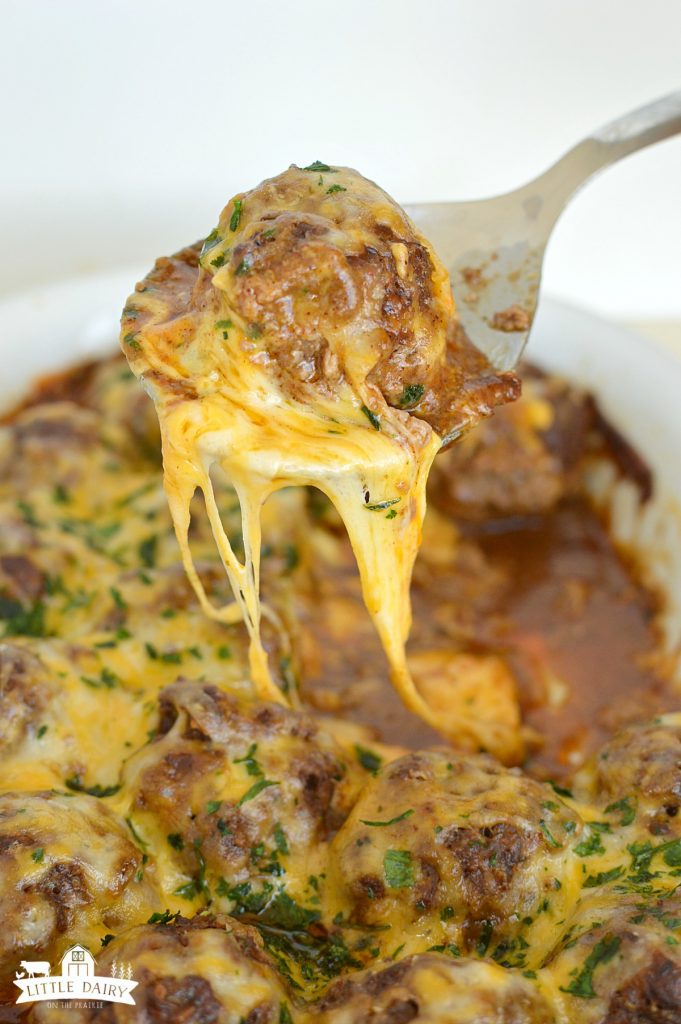A spoon with a cheesy meatball