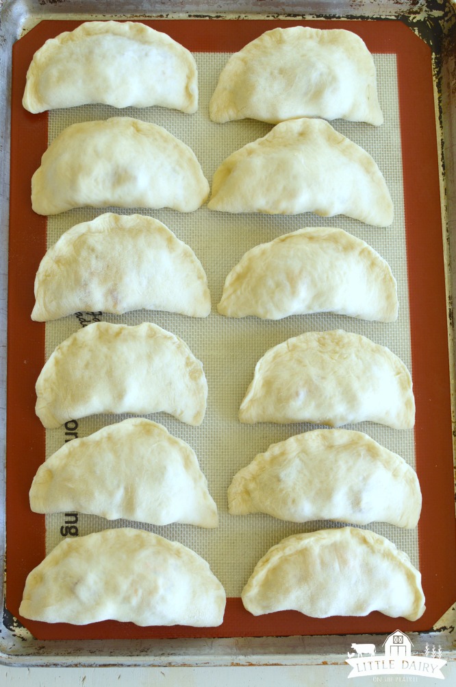 calzones on a baking sheet