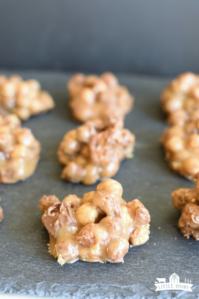 no bake peanut butter cereal cookies on a wax paper lined cookie sheet