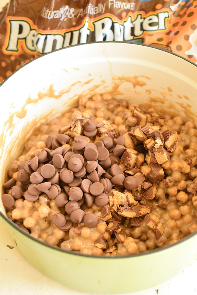 peanut butter cookie mixture in a pan topped with chocolate chips