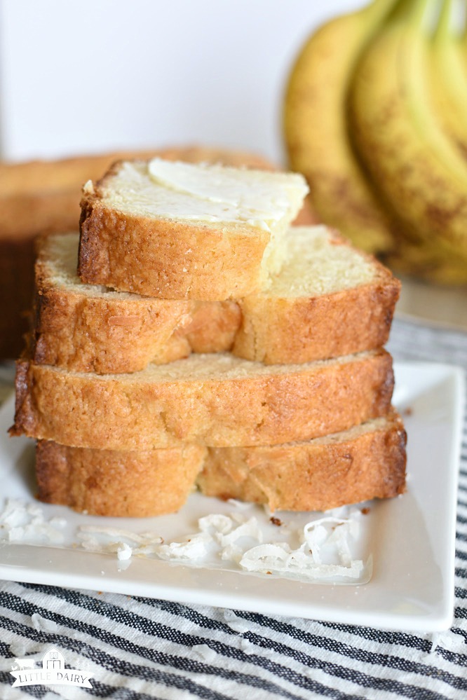 Coconut Banana Bread is my new favorite go to banana bread recipe! It’s a light quick bread that’s perfectly sweetened! The addition of coconut brings the best flavor to this bread! One time when I was a kid my family visited a couple elderly friends of ours. They had a dish of candy on the end table, of course I wanted one. I politely sat there and eyed the candies until I couldn’t help myself. I blurted out, “Can I please have one of those?” My dad was horrified that I would ask our friends if I could have a candy. The candy was there’s and I quickly remembered what I already know...you don’t ask people if you can have something that belongs to them. Let’s just say I got in trouble. Okay, it was big trouble and I never asked for anything again! A few years ago I went to visit my friend, Andra. Her house smelled amazing and she was just taking a couple loaves of Coconut Banana Bread out of the oven! Holy cow did I ever want her to share a slice of that warm bread with me! Of course I didn’t ask her and I don’t think I even sat there and eyed the bread. She must have read my mind, or maybe it’s just because she’s super nice, either way she offered me a slice of bread! Lucky me! That bread was amazing and I don’t even like bananas! I’ve kept my love of her Coconut Banana Bread in the back of my mind, but since I don’t like bananas I try not to keep them around! Justin and the kids don’t go grocery shopping with me very often, so when they do they go hog wild adding all the junk I never buy. Junk like bananas, licorice, barbecue potato chips, and corndogs! The dang boys devoured all the licorice and barbecue chips and left the bananas on the countertop until they were overripe. Their crazy shopping spree now meant I had to take care of the overripe bananas! I’ve literally tired a million banana bread recipes (the boys buy bananas every single time they go shopping and never eat them, maybe they really don’t like bananas just banana bread) over the years and this one is my favorite! Well, I’m still in love with Strawberry Banana Bread and Chunky Monkey Muffins, but this is my new go to regular banana bread recipe! I happen to love the addition of coconut, some of my boys won’t even touch any food that contains coconut even though they’ve never tried it! There’s an easy fix to this problem. I add half of the batter to one bread pan, add coconut to the remaining batter, then put it in the pan. Problem solved. Coconut Banana Bread for me. No Coconut Banana Bread for them! This bread has a different texture than so many of the banana bread recipes I’ve tried. It’s not too cakey, not too heavy overly moist. It’s has a mild banana flavor which I love! You’ve got to add Coconut Banana Bread to your list of recipes to make when you have extra overripe bananas! It’s seriously so good that I might even bring my boys grocery shopping a little more often just so we’ll wind up with extra bananas!