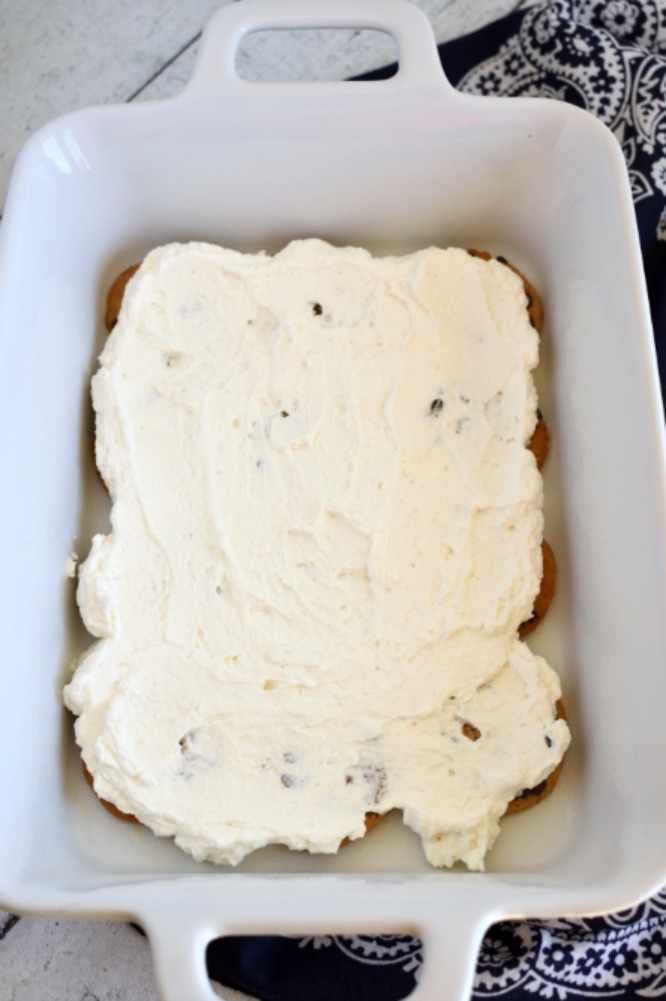 whipped topping spread over a layer of chocolate chip cookies