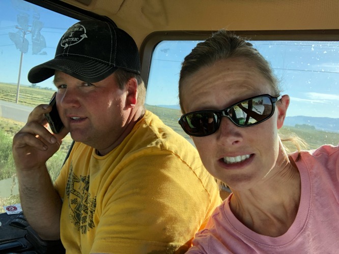 A man and a woman sitting in farm equipement