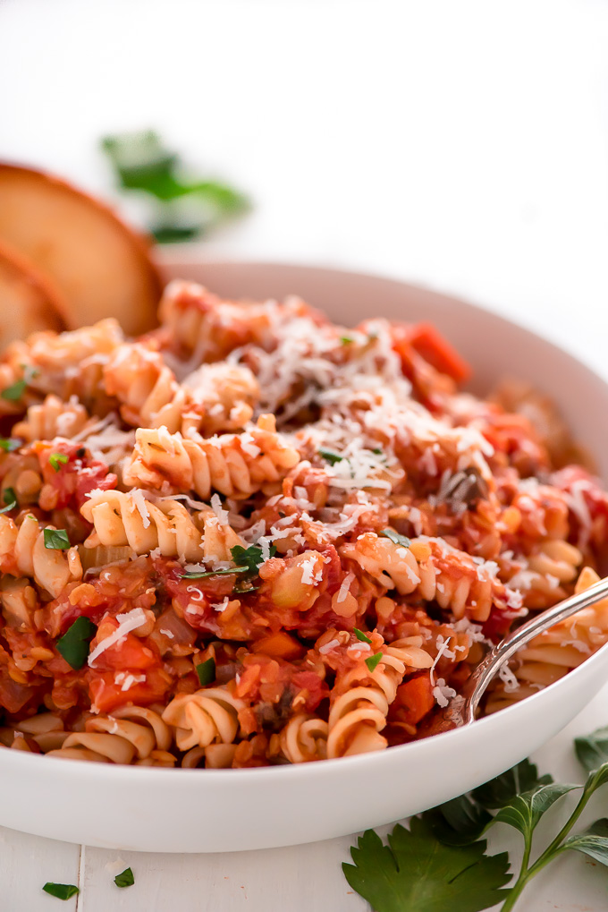 rotini pasta in a red sauce with grated parmesan cheese on top