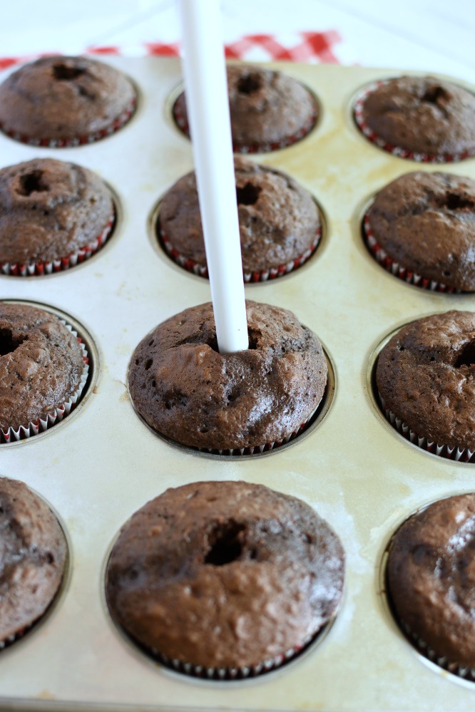 chocolate cupcakes poked with the end of a plastic spoon