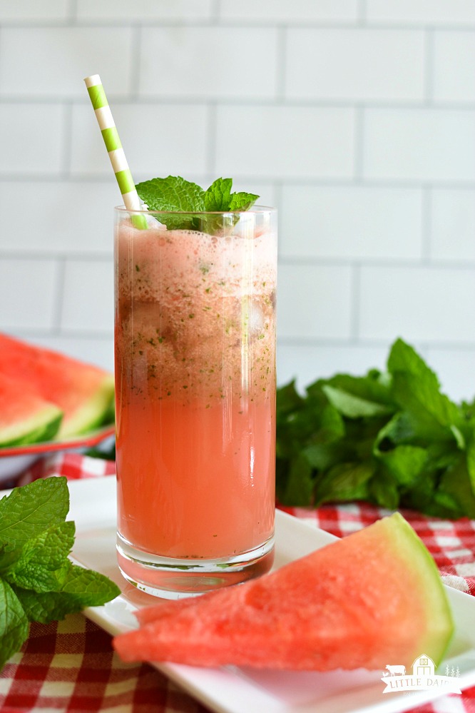 Red watermelon lemonade in a glass with mint leaves and a straw