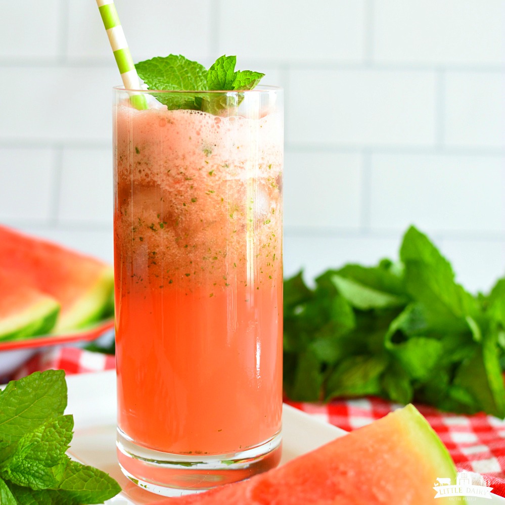 Red watermelon lemonade in a glass with mint leaves and a straw