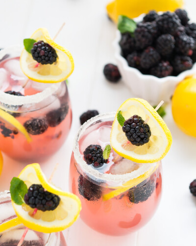 Lemonade in glasses with blackberries and lemon slices on top