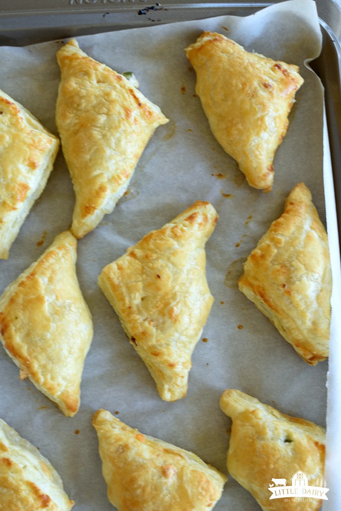 Baked puff pastry turnovers on a baking sheet