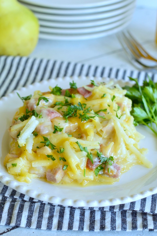 a white plate with a serving of hashbrown casserole