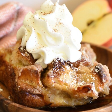Apple Pie French Toast Casserole on a plate with whipped cream