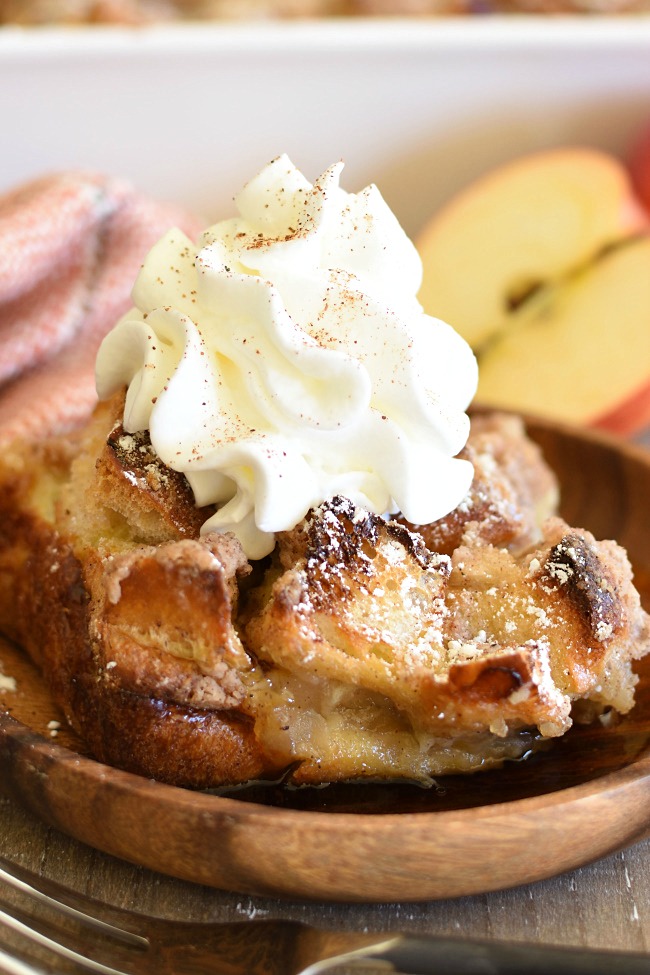 Apple Pie French Toast Casserole on a plate with whipped cream
