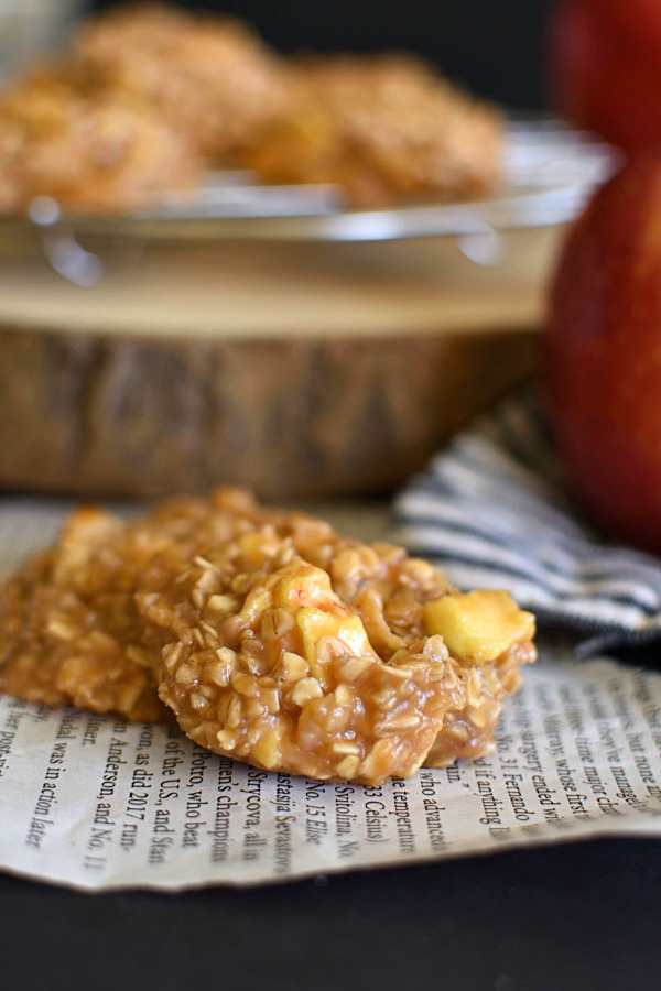 two no bake caramel apple cookies on a piece of newspaper