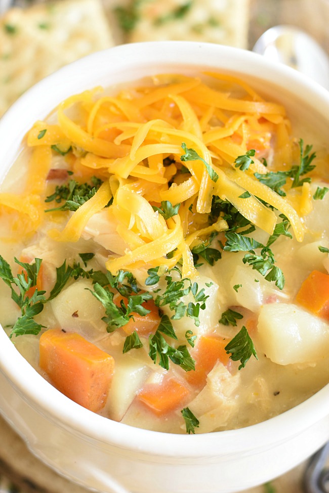 chicken, potato, and carrot soup with cheese on top