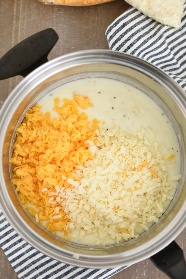 White sauce with grated cheese, in a saucepan