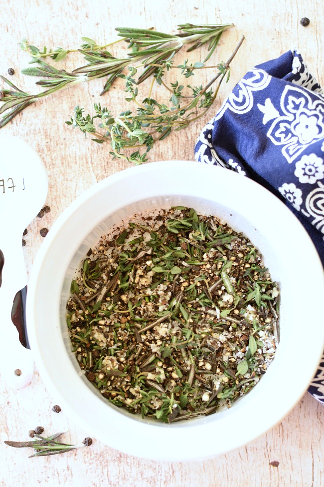 thyme, rosmeary, garlic, salt, and pepper in a bowl