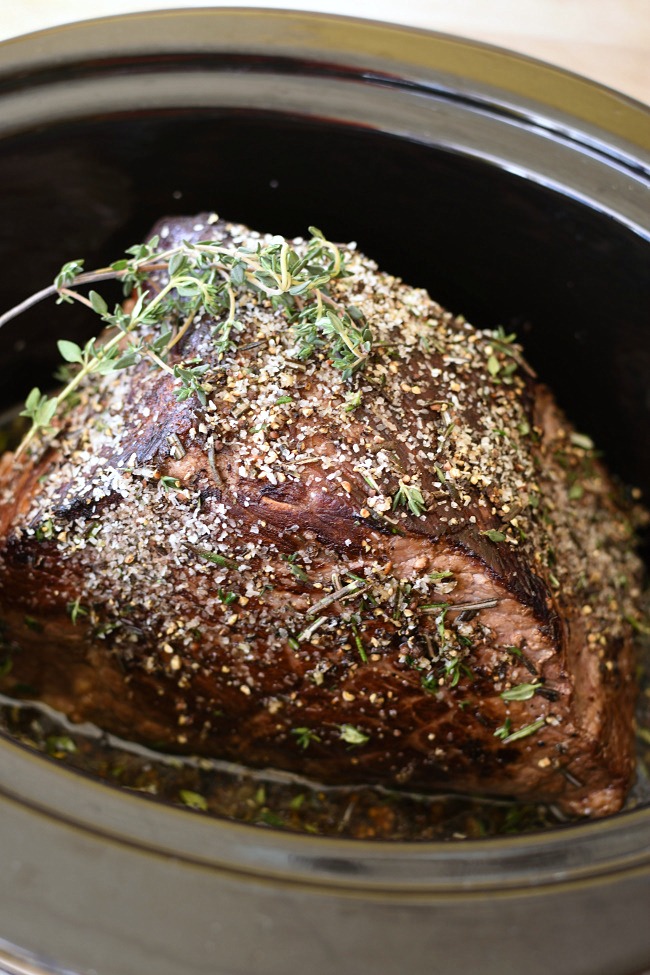 roast beef in a slow cooker with herbs