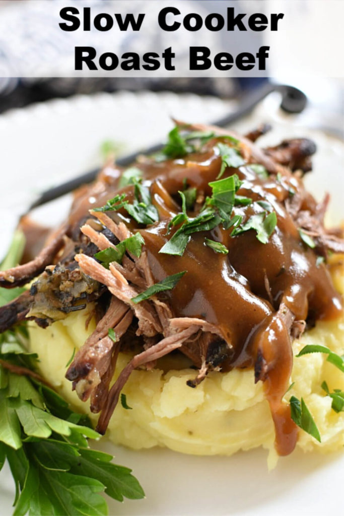 shredded raost beef on a pile of mashed potatoes drizzled in gravy