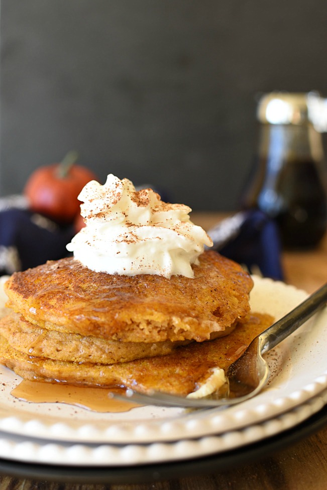 Whole Wheat Pumpkin Pancakes with whipped cream on top