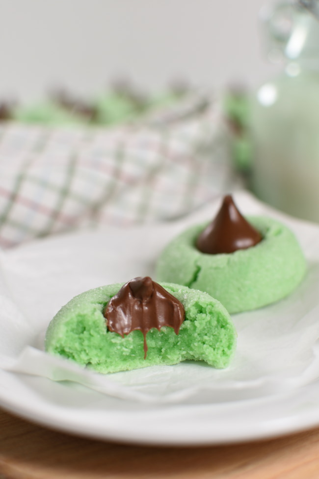 baked mint cookie with a chocolate kiss on it, with a bite taken out of it