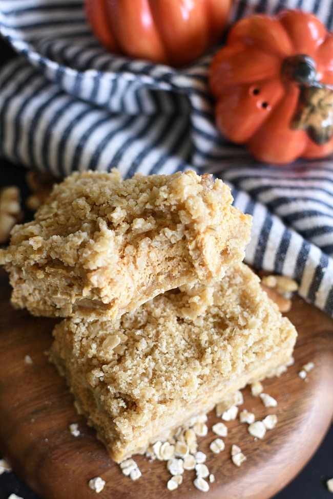 Pumpkin Cheesecake Oatmeal Crumb Bars with a bit taken out of it