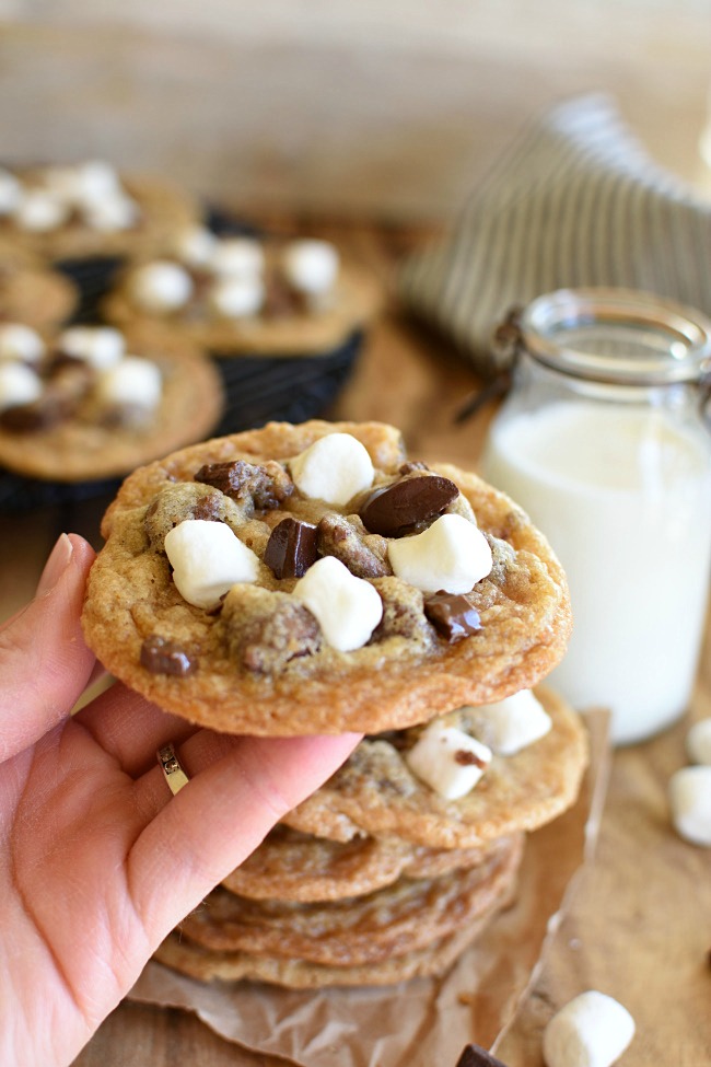 A hand holding a baked s'mores cookie