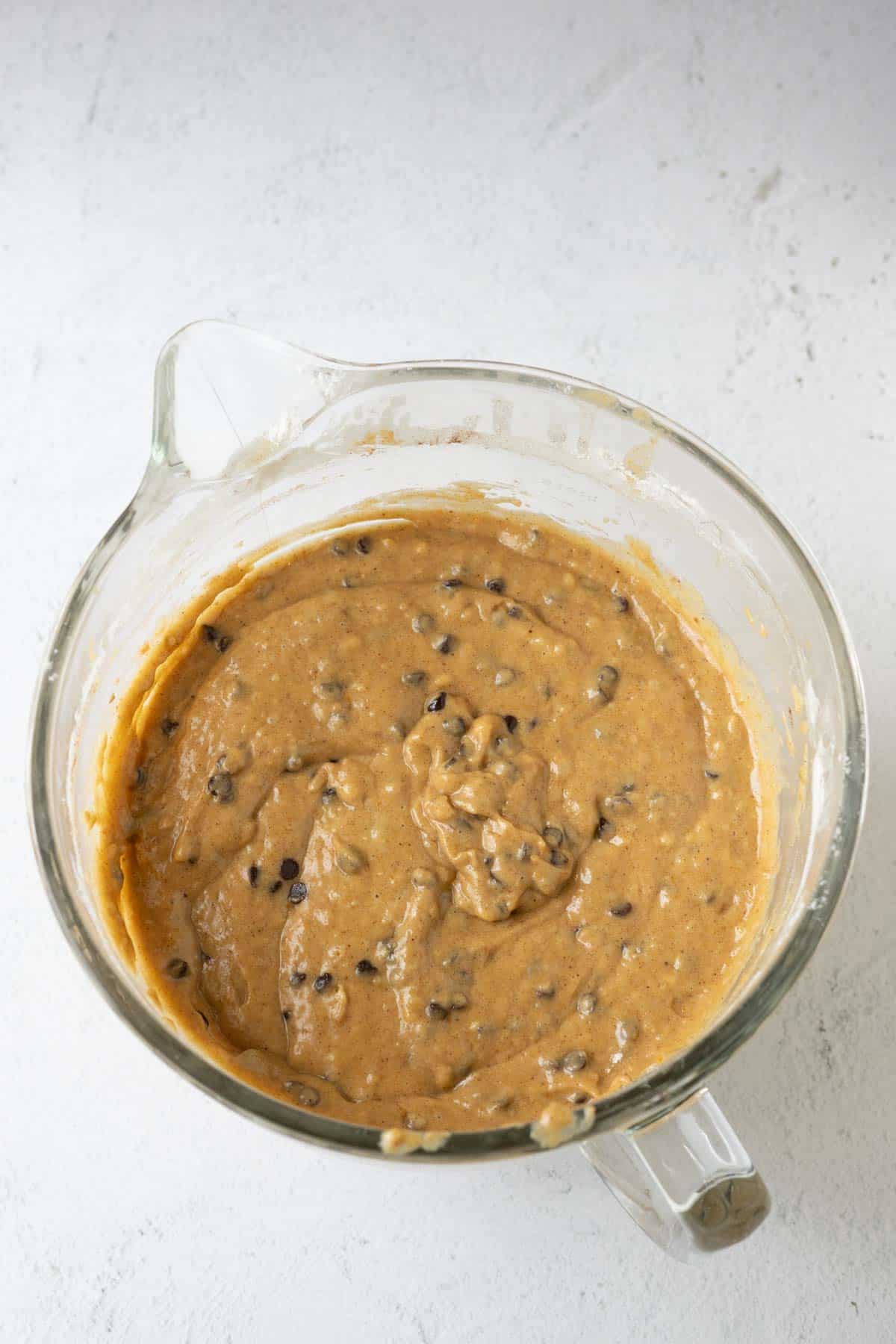 Pumpkin muffin batter with chocolate chips.