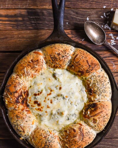 skillet bread with spinach artichoke dip in the middle