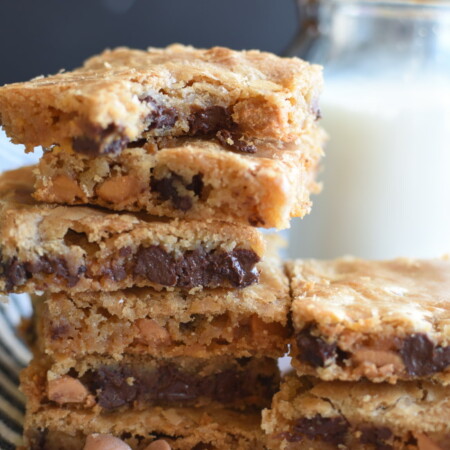 a stack of baked bar cookies with chocolate chips and butterscotch cookies