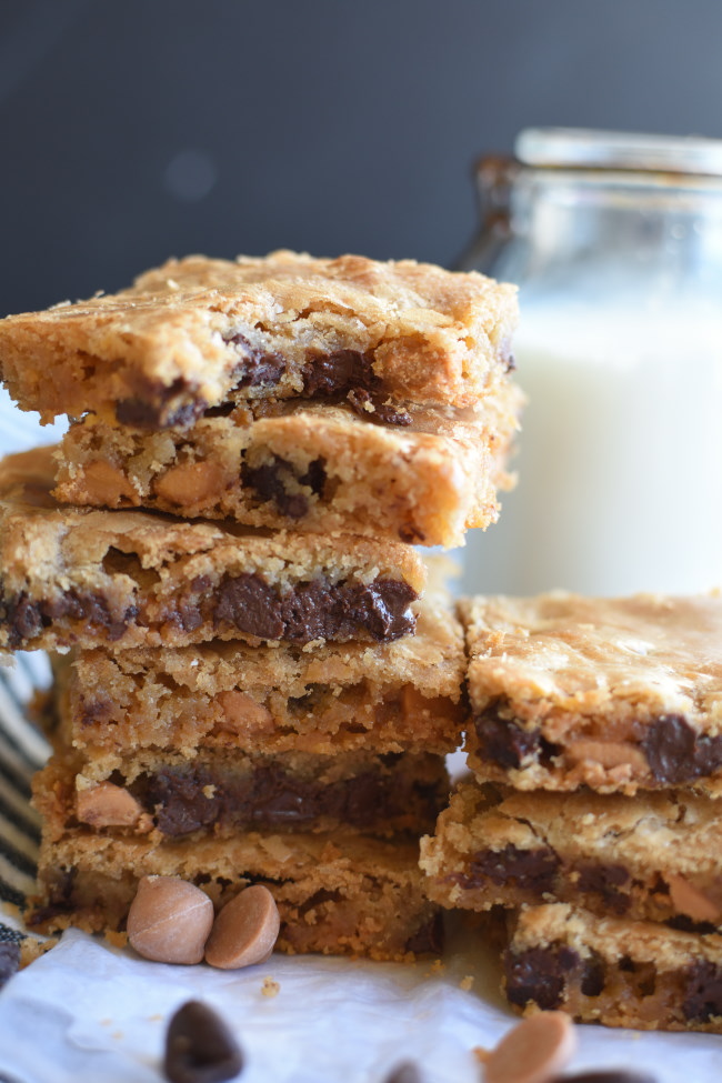 a stack of baked bar cookies with chocolate chips and butterscotch cookies