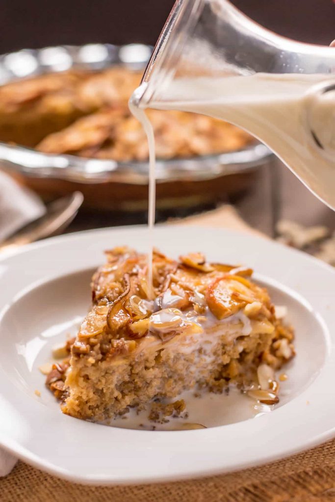 A slice of baked oatmeal with milk being drizzled on top