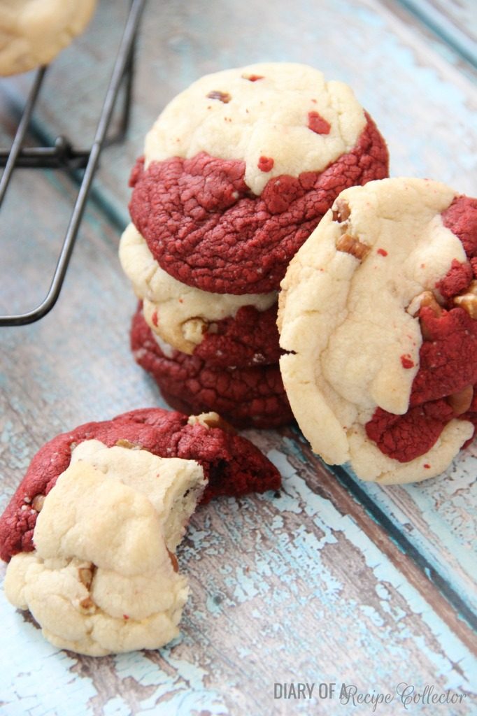 a stack of red and white marbled cookies and a cookie with a bite taken out of it