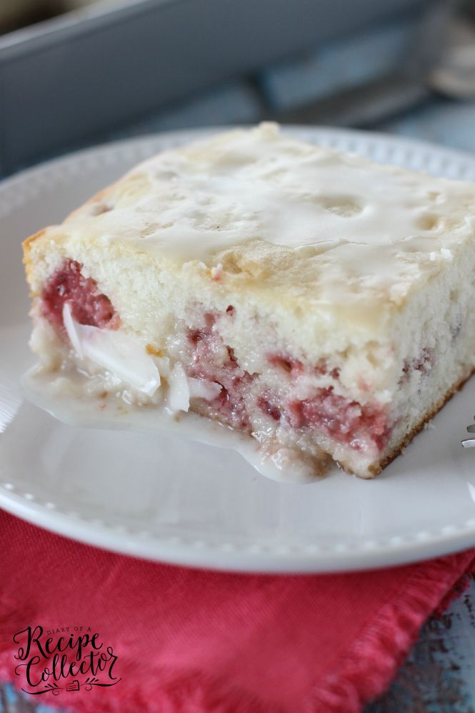 strawberry sour cream cake on a white plate