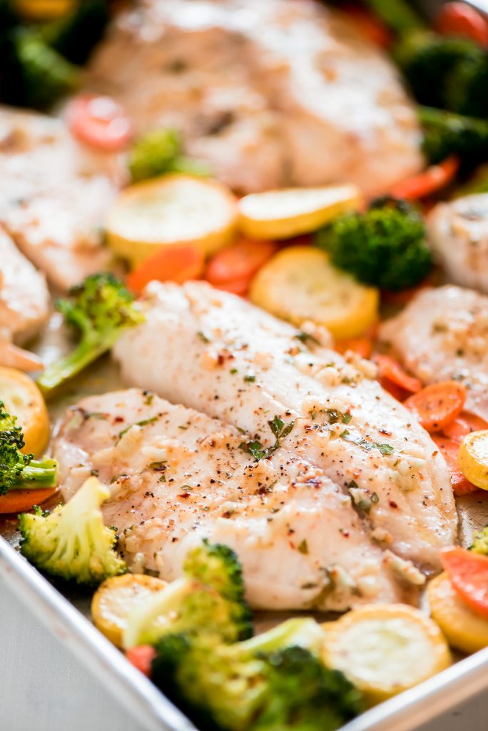 A sheet pan with roasted tilapia and vegetables